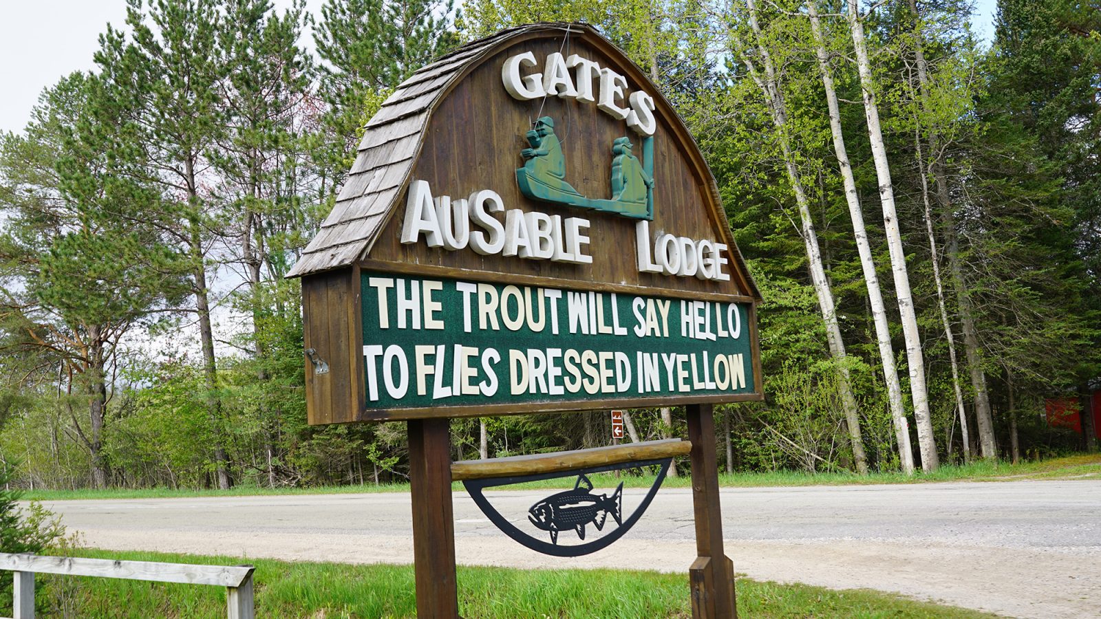 A welcoming sign of Gates Au Sable Lodge, inviting you to experience the tranquil beauty of the surrounding wilderness.